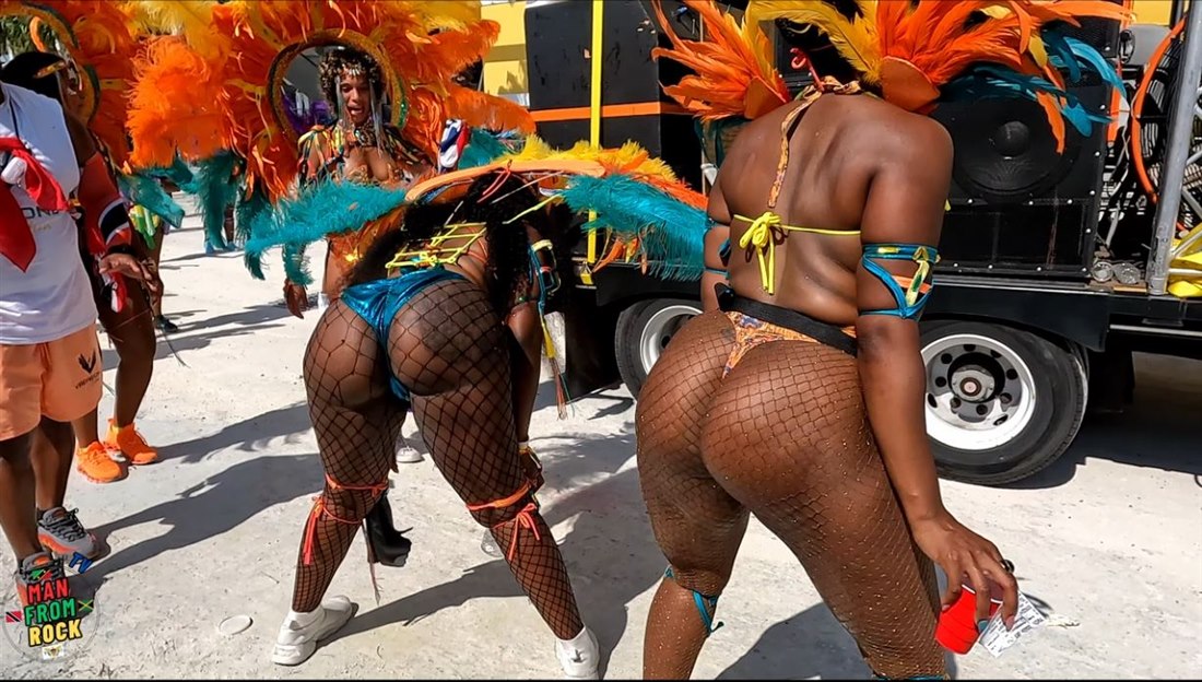 Carnival masqueraders in feathered costumes on the road